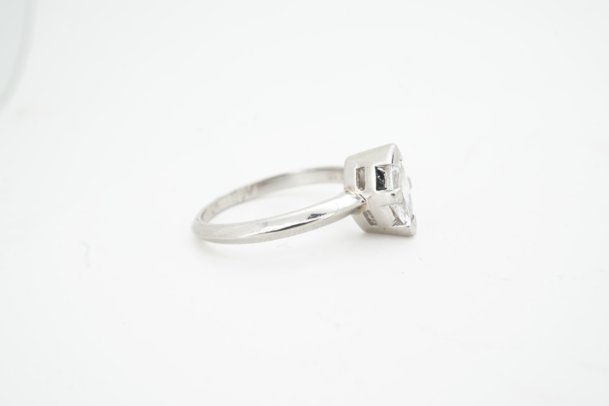 A diamond ring, claw-set with a marquise-shaped diamond weighing approximately 0.50 carats, mounted in platinum, size L, British hallmarks, gross weight approximately 4 grams